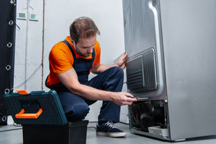 Fridge Repair AbuDhabi. Expert Technicians Working Photo